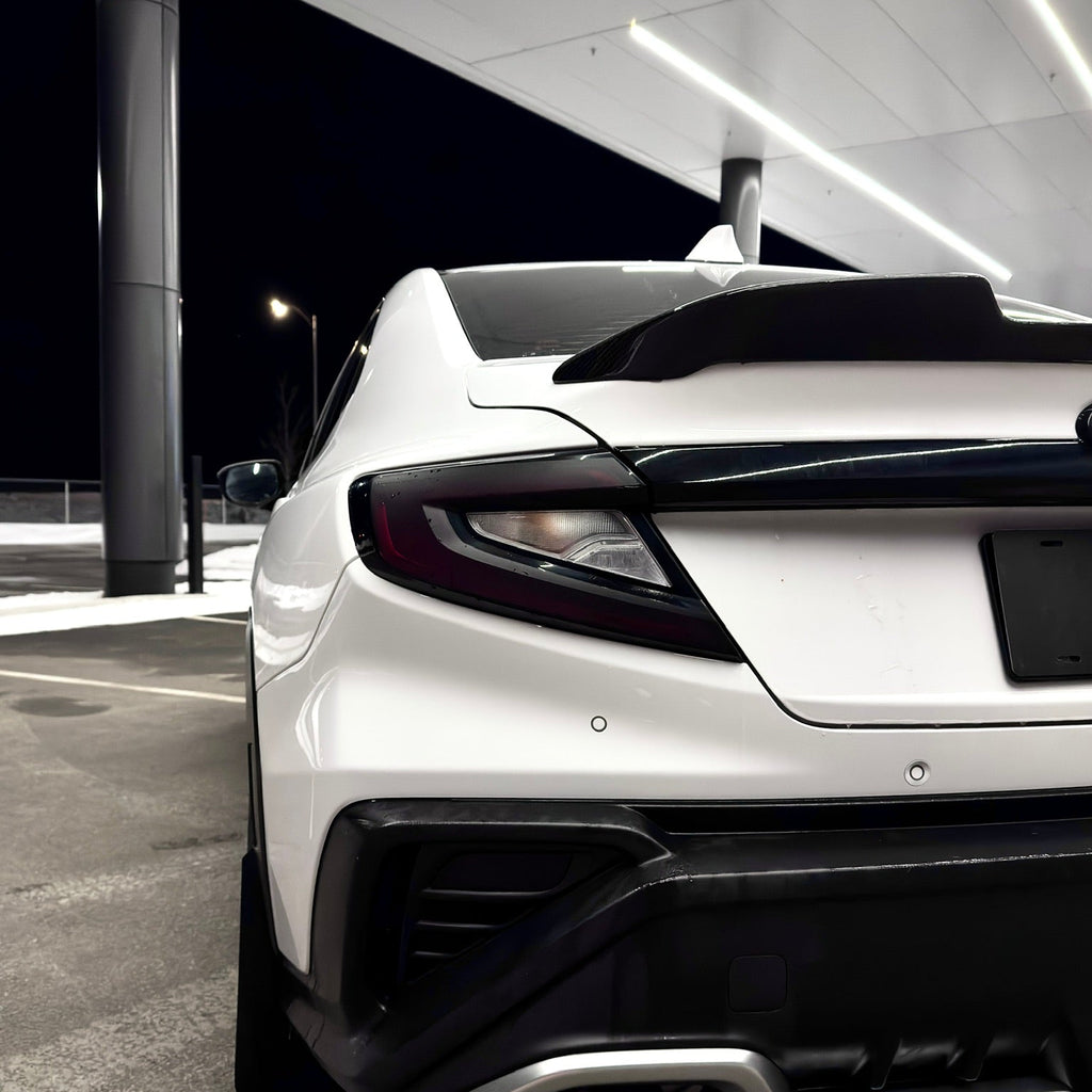 White car with black accents in a parking garage