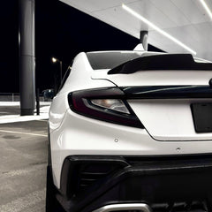White car with black accents in a parking garage