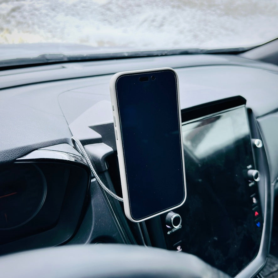 Phone mounted on a car dashboard using a magnetic holder