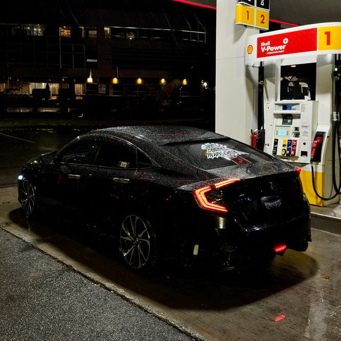 Black car at a gas station during nighttime