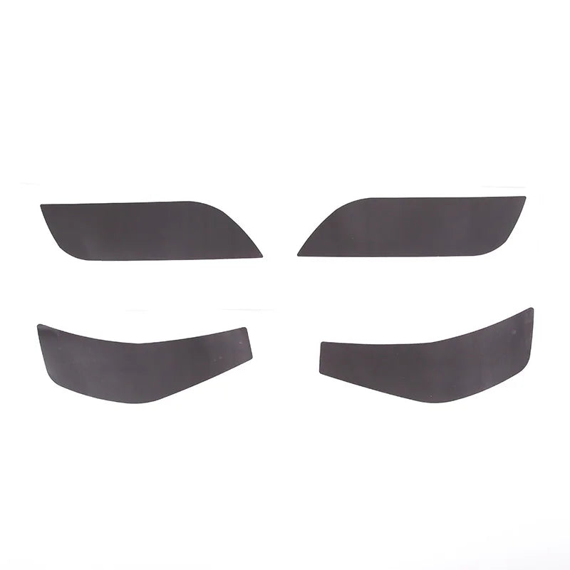 Four black car window sunshades on a white background