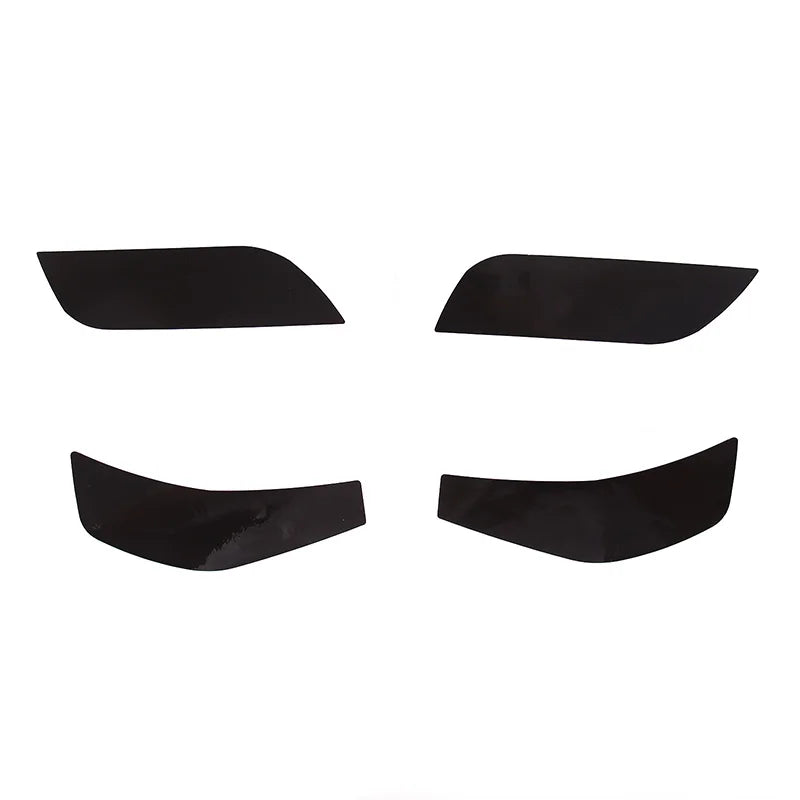 Four black car window sunshades on a white background