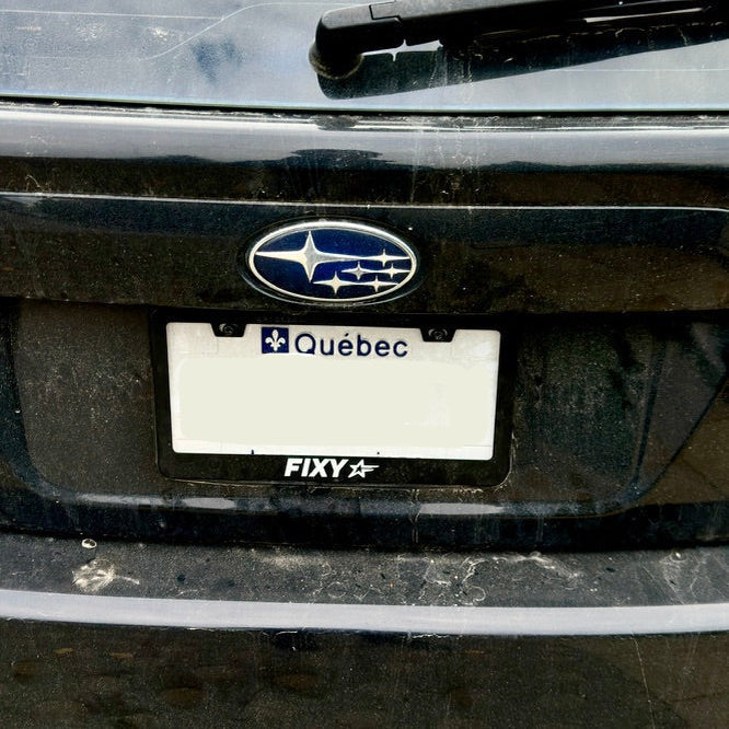 FIXY star design license plate frame on a black car