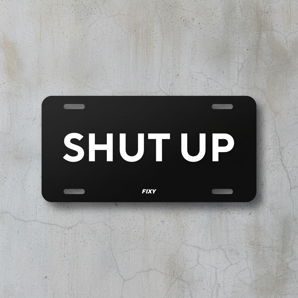 Black license plate with 'SHUT UP' text on a white background