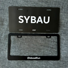 Black license plate with 'SYBAU' text on a gray textured background