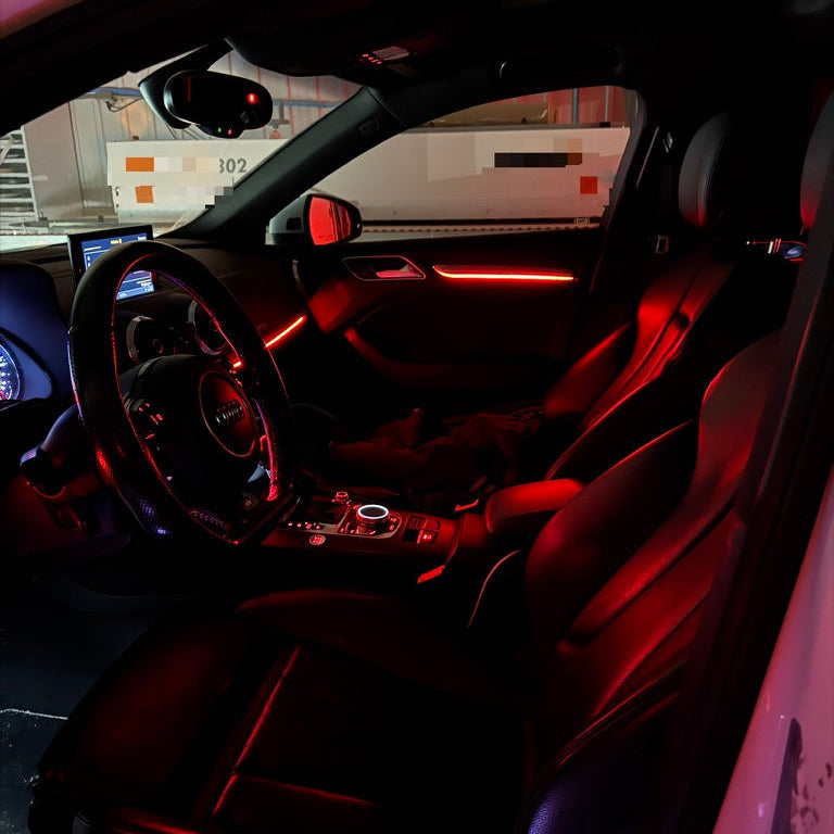 Car interior with red ambient lighting in a showroom setting