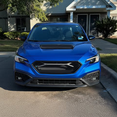 Blue car parked on a driveway in front of a house