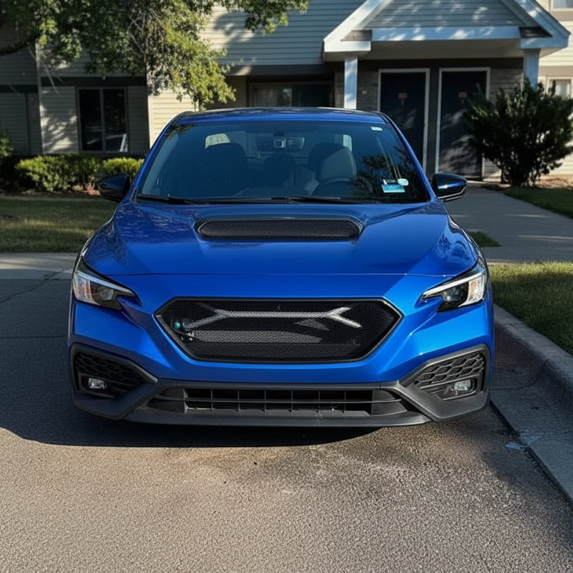 Blue car parked on a driveway in front of a house