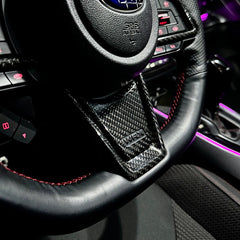 Steering wheel with Subaru logo in a car interior