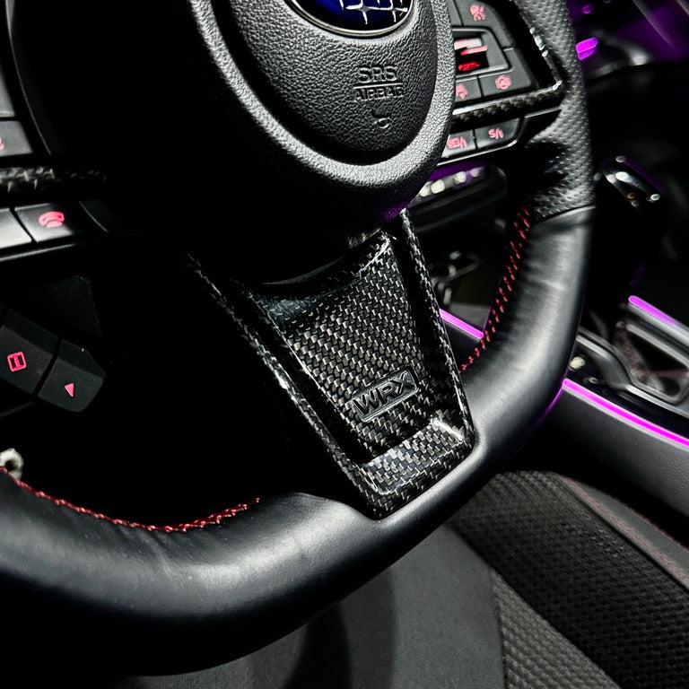 Steering wheel with Subaru logo in a car interior