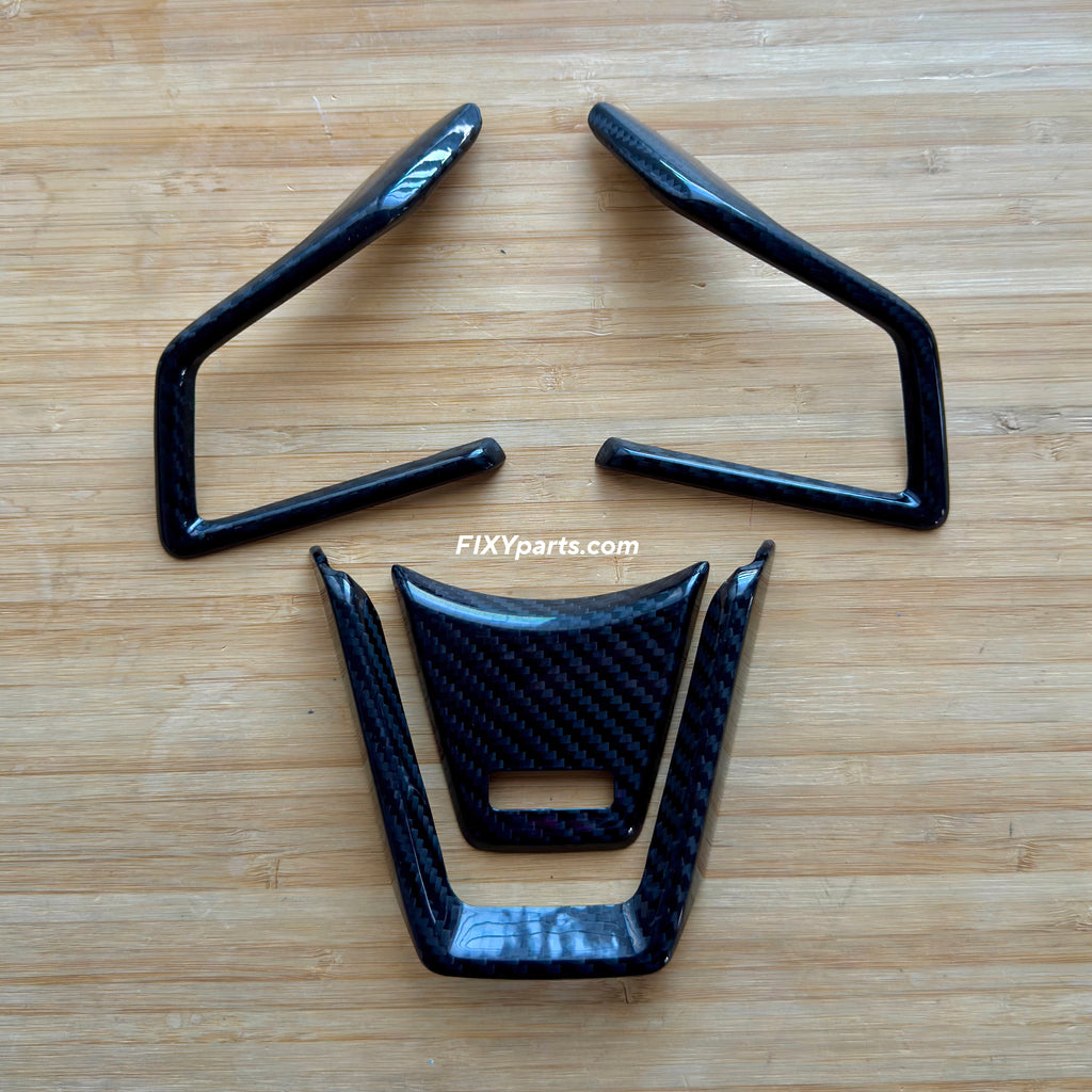 Carbon fiber car parts on a wooden surface with 'FIXYparts.com' branding.