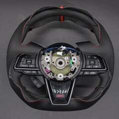 Car steering wheel with visible brand logo on a gray background