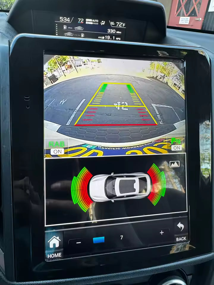 Car's rearview camera display on a touchscreen with parking assistance graphics.