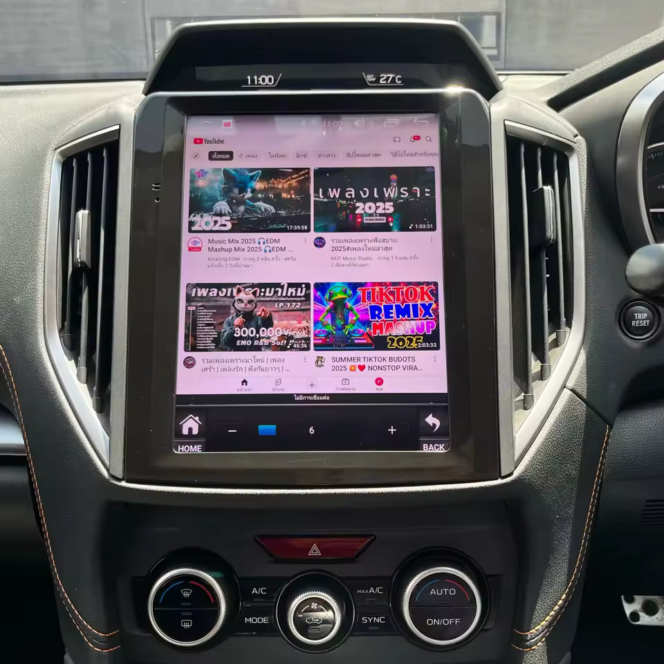 Car dashboard with a touchscreen display showing a music app interface.