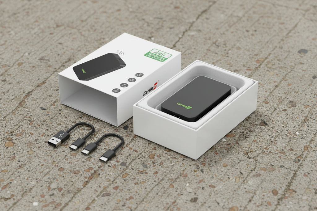 CarPlay and Android Auto device with cables and packaging on a white background