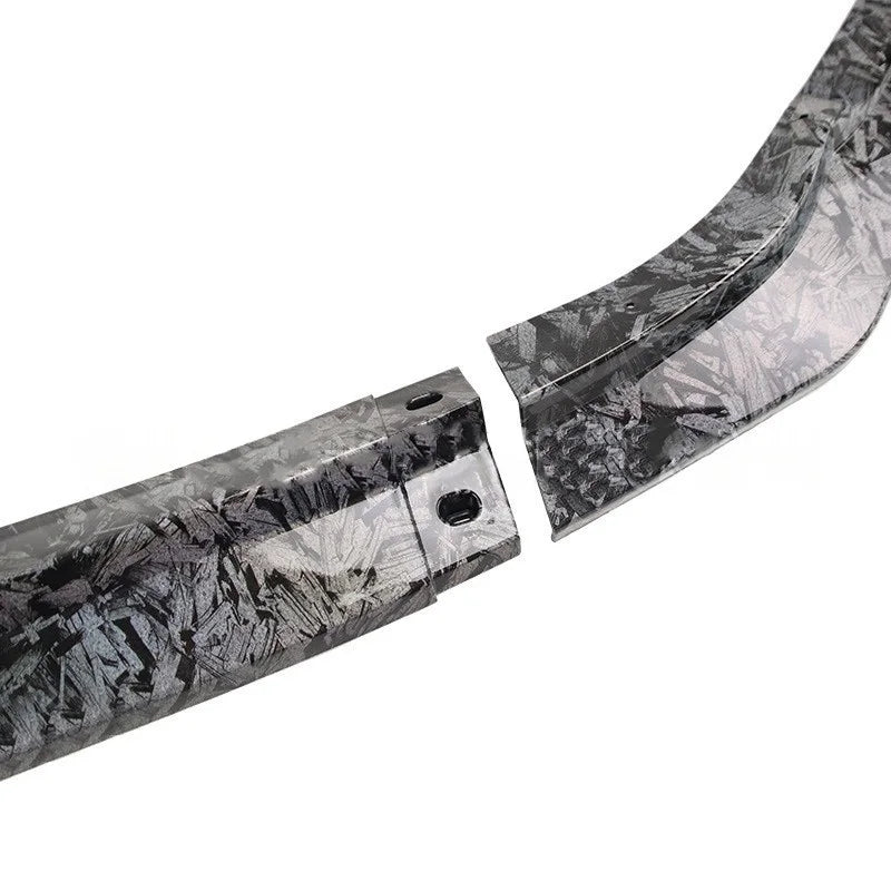 A close-up of a curved black and gray patterned strip or trim piece shown in two separated sections on a plain white background.