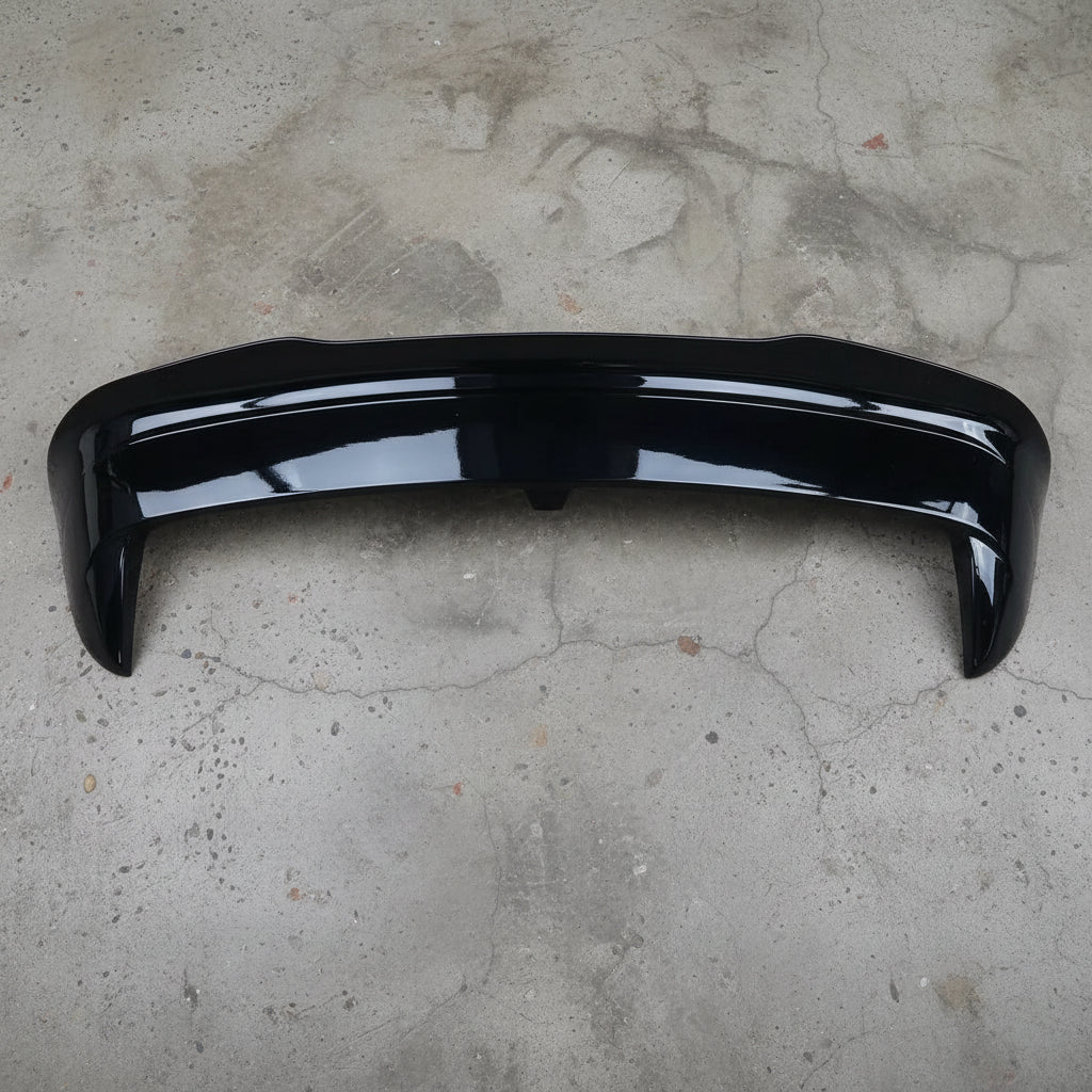 Black car spoiler on a gray surface