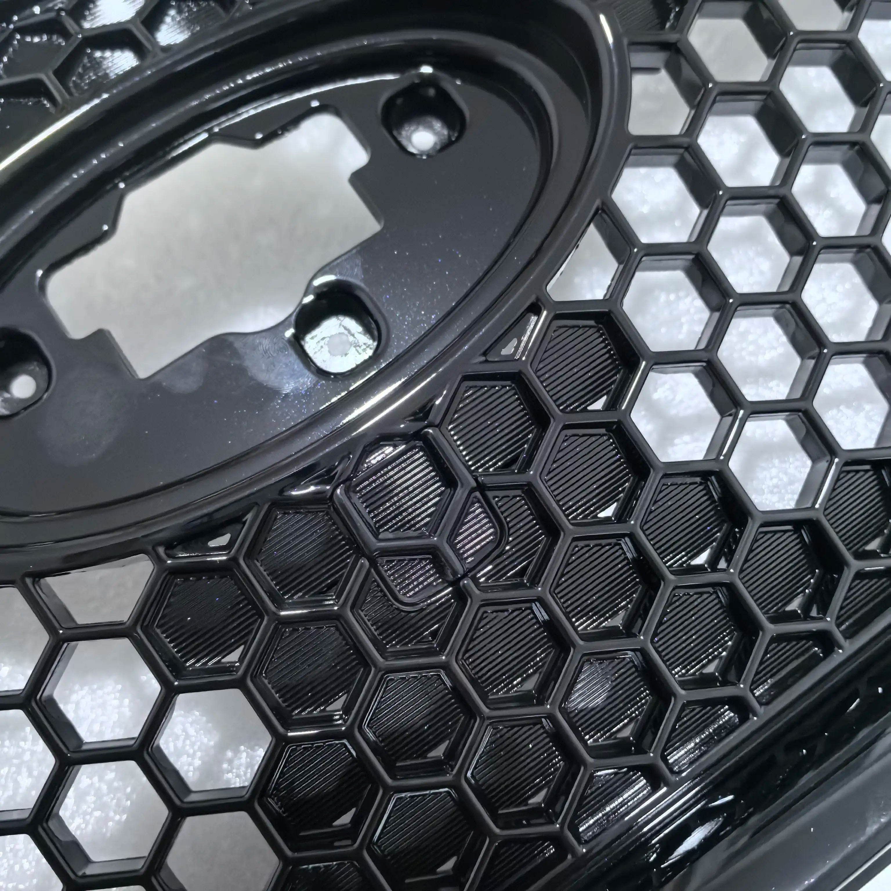 Close-up of a black honeycomb grille on a vehicle