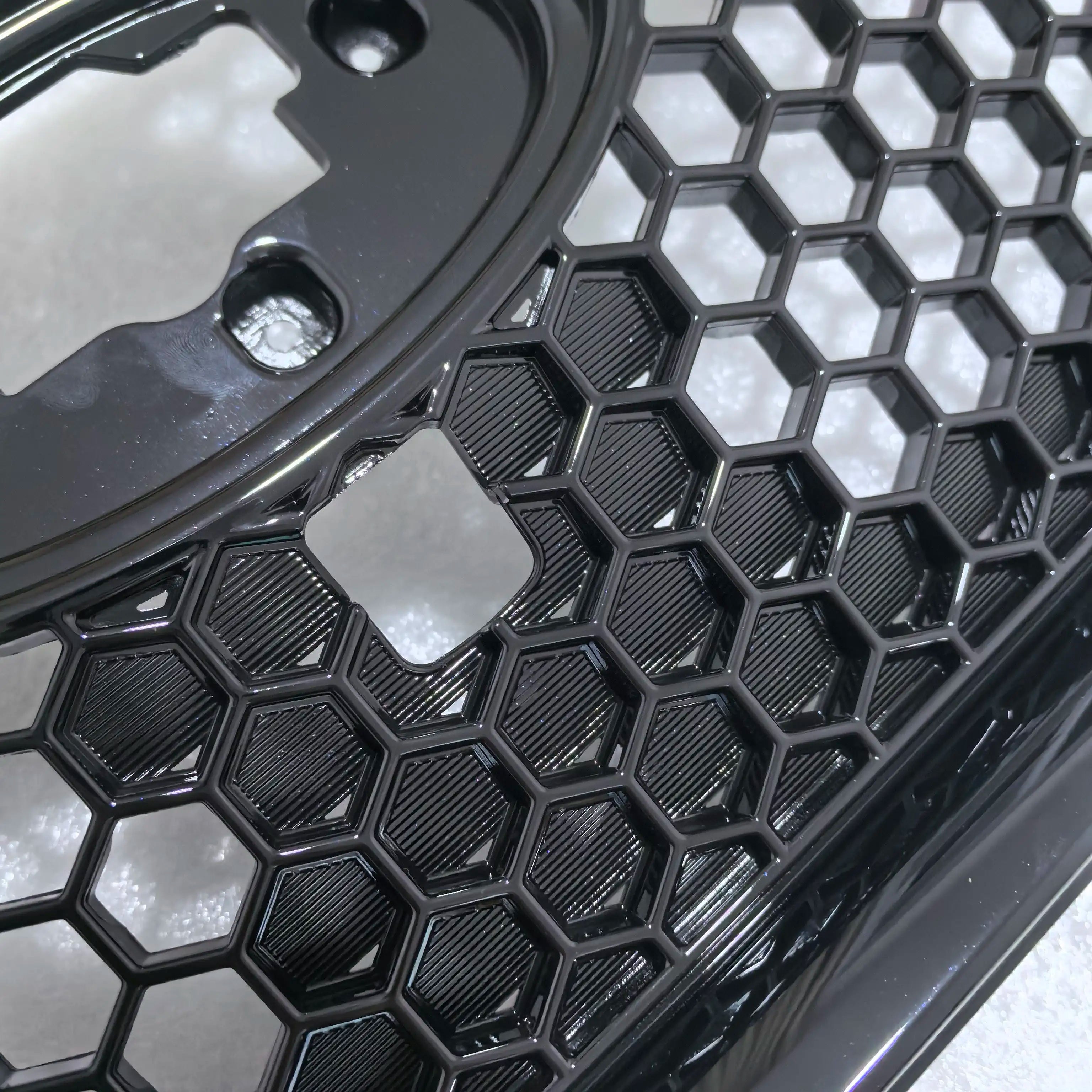 Close-up of a car grille with honeycomb pattern