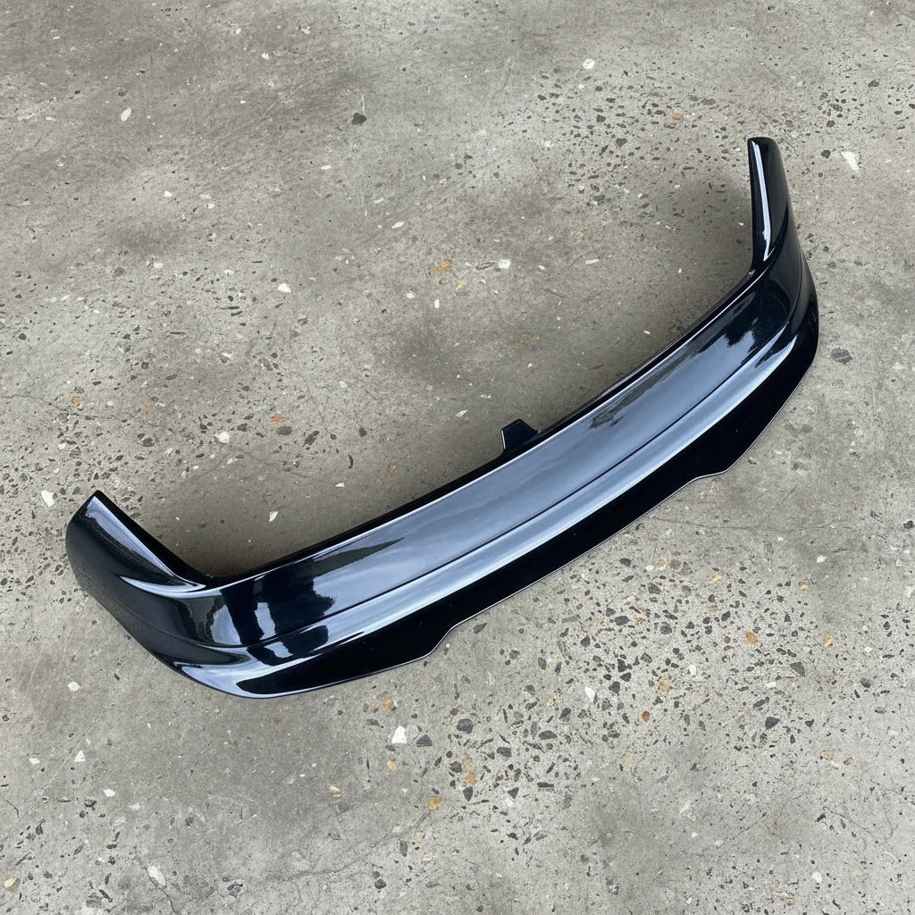 Black car spoiler on a beige background