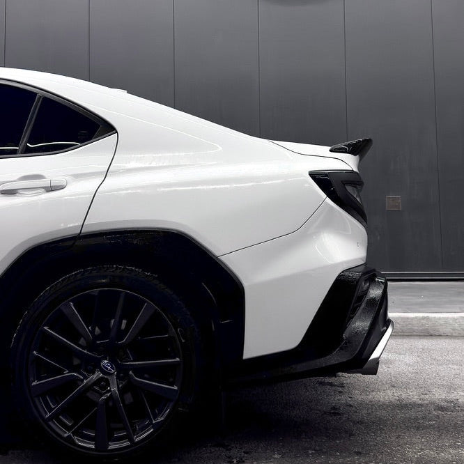 White car parked in front of a building with 'pace67' branding.