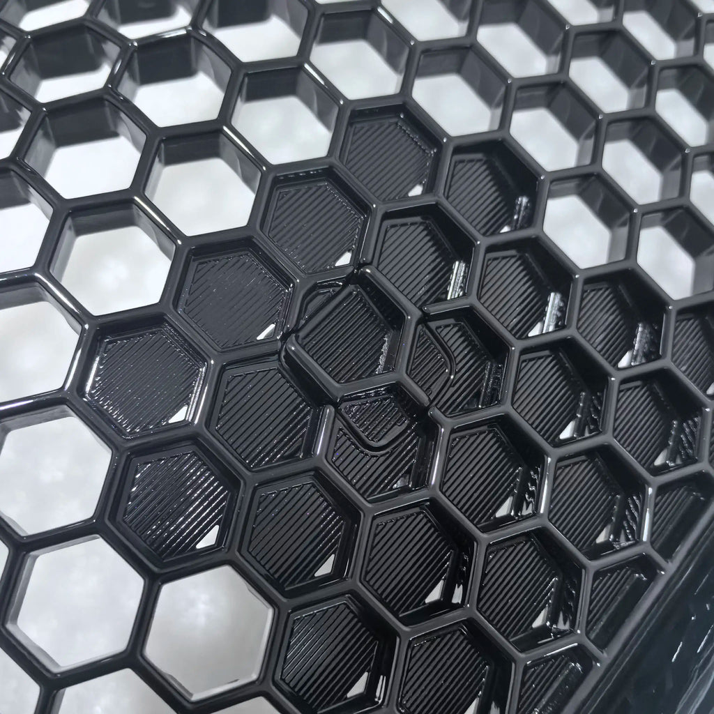 Close-up of black hexagonal tiles with a reflective surface