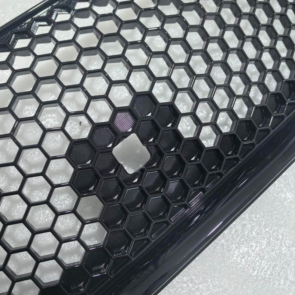 Close-up of a honeycomb-patterned black and white grille