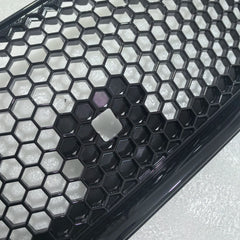 Close-up of a honeycomb-patterned black and white grille