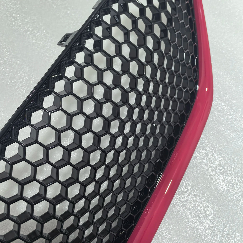 Car grille with honeycomb pattern and red border on a gray background